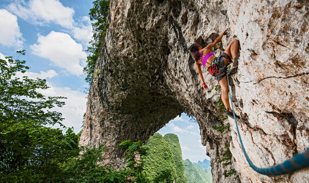 young female climbing on Moon Hill in Yangshuo, China
