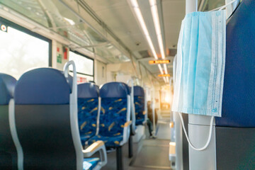 Empty inside train bus subway public transport with window view and blue seats people tourist new normal social distancing safe travel with hygiene face mask protect from covid corona virus