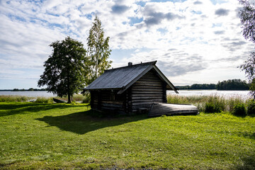 Obraz premium vintage houses and churches wooden architecture north in summer against blue sky background
