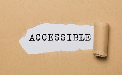 The text ACCESSIBLE, appearing behind torn paper. The craft paper is ripped.