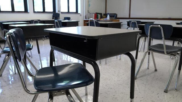 Motion to the right showing empty school classroom with chairs under desks. Concept for pandemic.