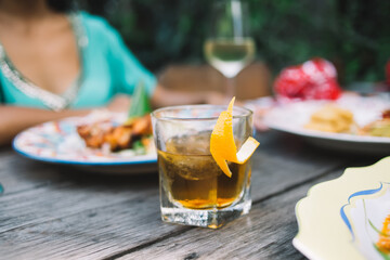 Fresh beverage with orange on table