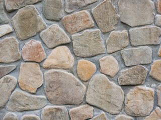 Seamless textured stone wall. Neatly stacked rough cobblestone wall texture background.