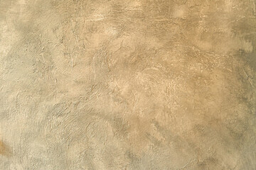 Concrete wall illuminated by sun. Background from unevenly Primer wall