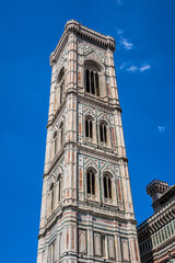 Fototapeta na wymiar Eighty-five meter high tower Giotto's Campanile (designed in 1334 by Giotto di Bondone) - bell tower of the Basilica di Santa Maria del Fiore. Florence, Italy.