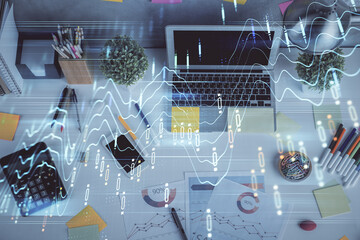 Multi exposure of forex chart drawing over table background with computer. Concept of financial research and analysis. Top view.