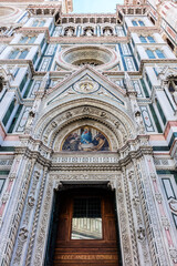 Fototapeta na wymiar Cathedral Santa Maria del Fiore (or Duomo di Firenze), was built between 1296 and 1436. Cathedral is one of largest in world. Architectural fragments of front facade. Piazza del Duomo, Florence, Italy