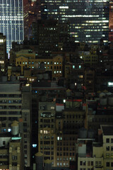 Fototapeta na wymiar New York City rooftops and water tanks at night