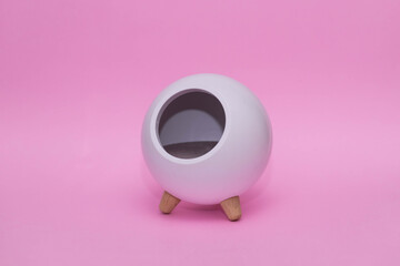 white night lamp in the shape of a ball on legs on a pink background.Children's lamp. with place for text
