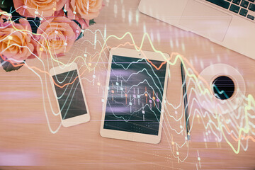 Multi exposure of forex graph hologram over desktop with phone. Top view. Mobile trade platform concept.
