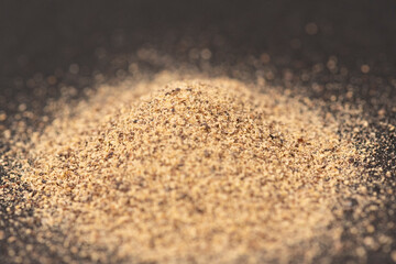 Powdered black ground pepper. Macro on dark background
