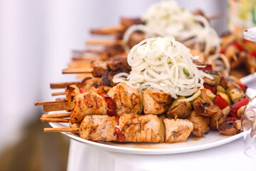 Shish kebab on wooden skewers is on a plate