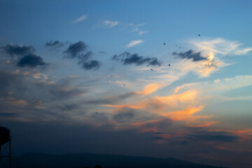 Obraz na płótnie Canvas colorful sunset landscape with clouds and birds