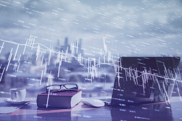Double exposure of financial chart drawings and desk with open notebook background. Concept of...