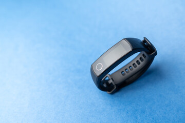 fitness bracelet on blue background
