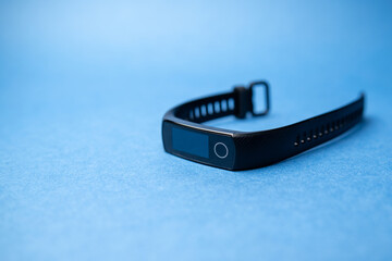 fitness bracelet on blue background