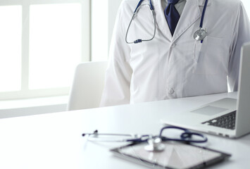 Doctors working on computer at hospital.