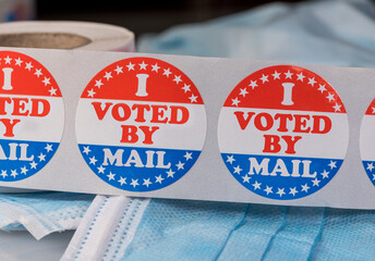 I Voted by Mail sticker on protective face mask for absentee ballot or mail-in voting in the...