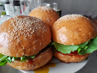 Delicious homemade hamburgers with beef cutlet, cheese, onion, tomato and lettuce