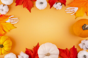 White and orange heirloom pumpkins, cotton flower on orange backdrop. Halloween background. Space for text. Autumn red maple leaves. Sales flat lay. Thanksgiving holiday template with empty space