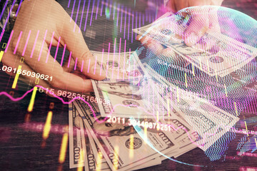 Multi exposure of financial graph drawing hologram and USA dollars bills and man hands. Analysis concept.
