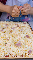 elderly woman white mother cutting sausages and sausages to make pizza