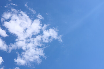 Blue sky with a fluffy cloud. Copy space. Wallpaper