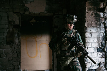 Soldier in combat. Urban combat training, soldier entering abandoned building. Anti terrorist operation battlefield training.