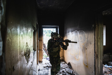 Soldier in combat. Urban combat training, soldier entering abandoned building. Anti terrorist...