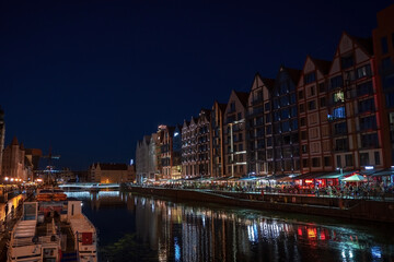 Fototapeta na wymiar Gdansk, North Poland : Night photograph of medieval style polish architecture over motlawa river