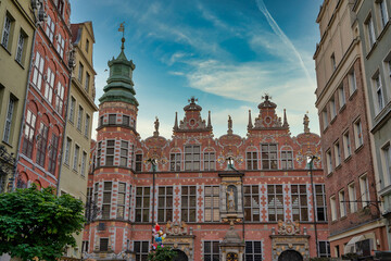 Fototapeta premium Gdansk, North Poland - August 13, 2020: Wide angle shot of a Long Lane street in Old town displaying Polish architecture against blue sky
