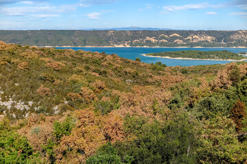 Lake of Sainte-Croix with blue melting water with forest mountains around, commune of Les Salles-sur-Verdon, region of Provence-Alpes-Côte d'Azur, Alpes de Haute Provence, France