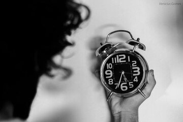 person holding clock
