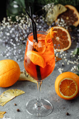 Aperol spritz cocktail on a gray concrete background. a glass of aperol spritz with orange slices....