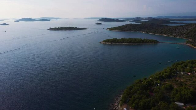 Amazing aerial view panning up revealing coastline of Dalmatia, Croatia filmed in 4k with clear water, beaches and rocky shore of the Adriatic Sea.