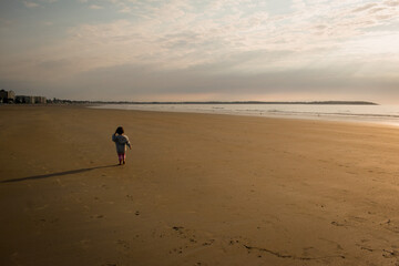 Solitude walking on the beach at sunrise