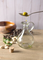 Olive on he spoon and empty bottle