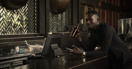 Fototapeta na wymiar african american businessman relax and enjoy drink beer at counter bar