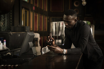 african american businessman relax and enjoy drink beer at counter bar