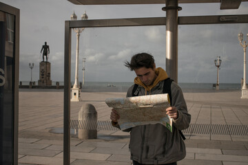 young man with map travel concept vacation adventure travel advertising gps campaign, airport opening, public transport, transportation, maps