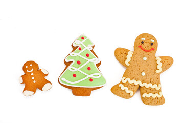 Christmas cookies - gingerbread men and holiday fir isolated on a white background. Top view.