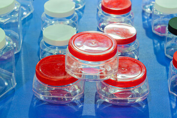 Group of Translucent Square plastic jar with red lid and white lid. Ready to use for package design. Selective Focus