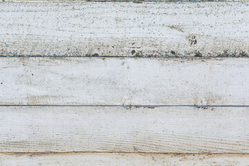Antique, cracked white wood surface as texture. Ideal for backgrounds. The boards are laid horizontally