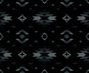 Motif géométrique ethnique tribal sans couture dans le style pixel en vecteur pour la mode