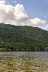 Fototapeta na wymiar Paul Lake Summer time with green mountains and white clouds british columbia canada.