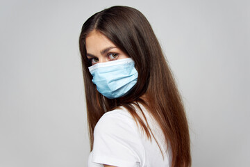 Woman in medical mask look ahead long hair cropped view 