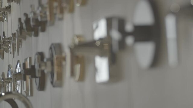 focus change in a still shot of lots of shower handles