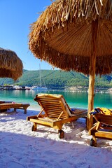 Fototapeta premium Bodrum, Turkey - August 2020: Hotel beach Lujo. Beautiful tropical beach banner. White sand travel tourism wide panorama background concept. Amazing beach landscape, yachts, Luxury tourism