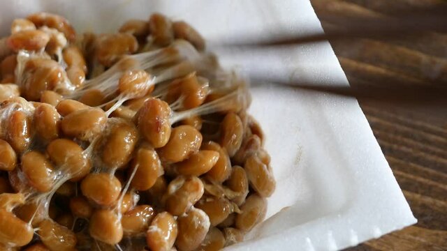 容器に入った納豆を混ぜてる動画。右から左へのスライド。