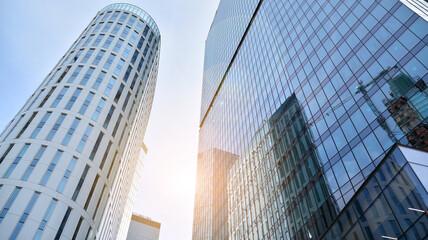 Office building, details of blue glass wall and sun reflections.